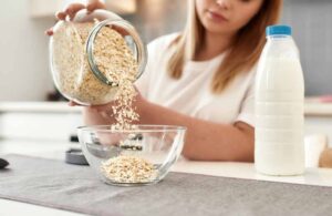 placing oats in a bowl on the table